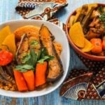 Thieboudienne Rouge served in bowls with vegetables.