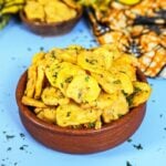 Kenyan Bhajias served on a platter with sauce.