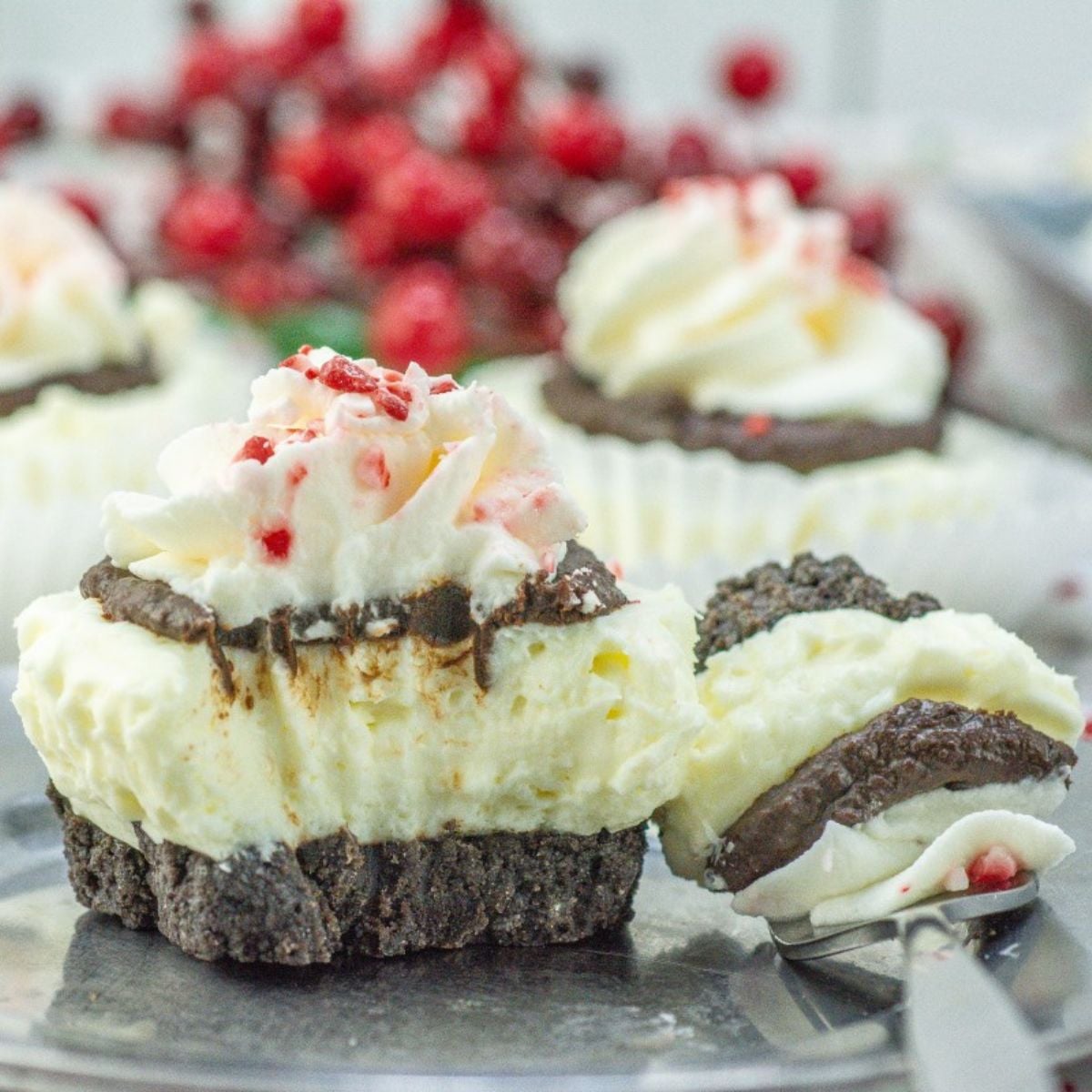 Peppermint Cheesecake Cupcakes with whipped cream and crushed peppermint