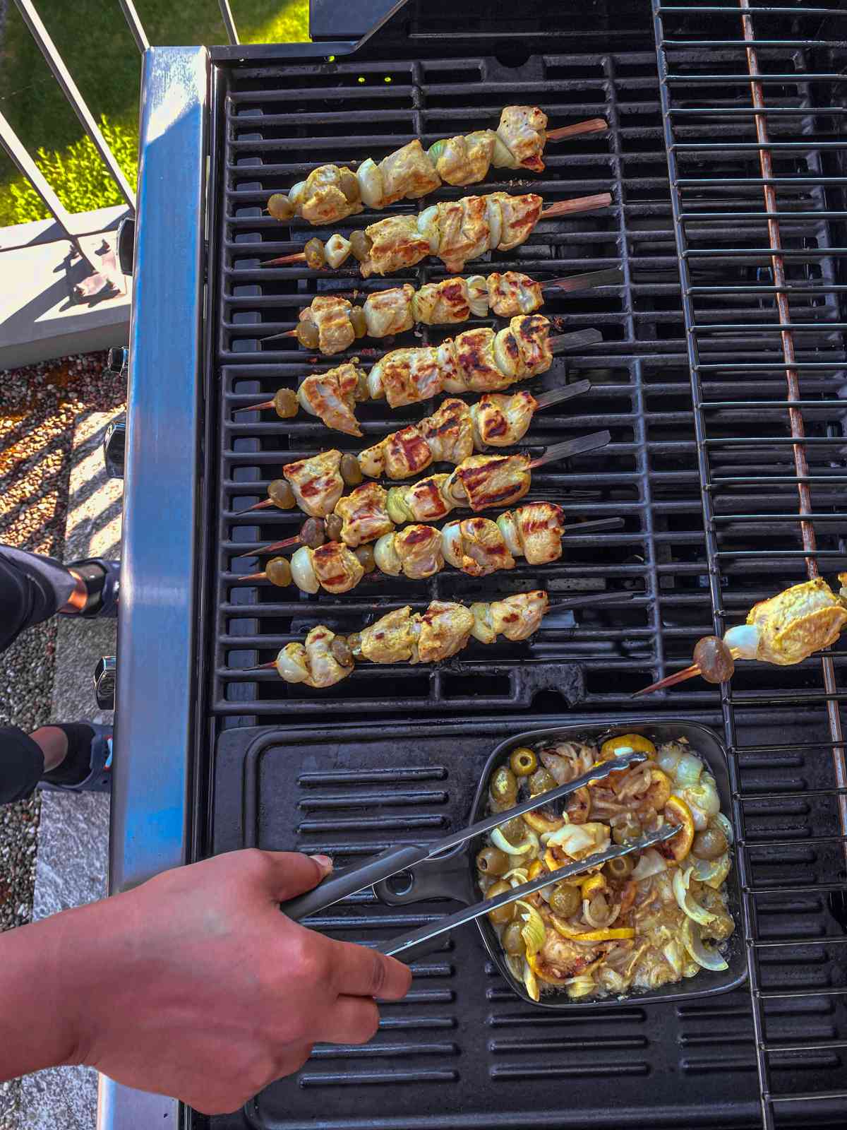 grilling close up Senegalese Poulet Yassa Skewers.