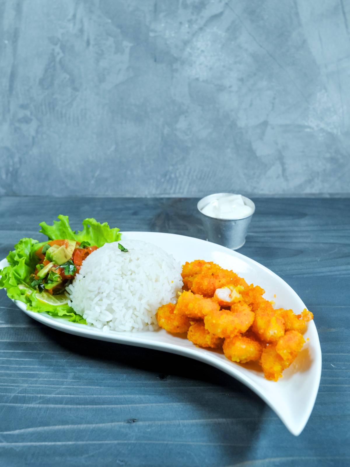 Camarones Empanizados with rice and salad. on blue background.