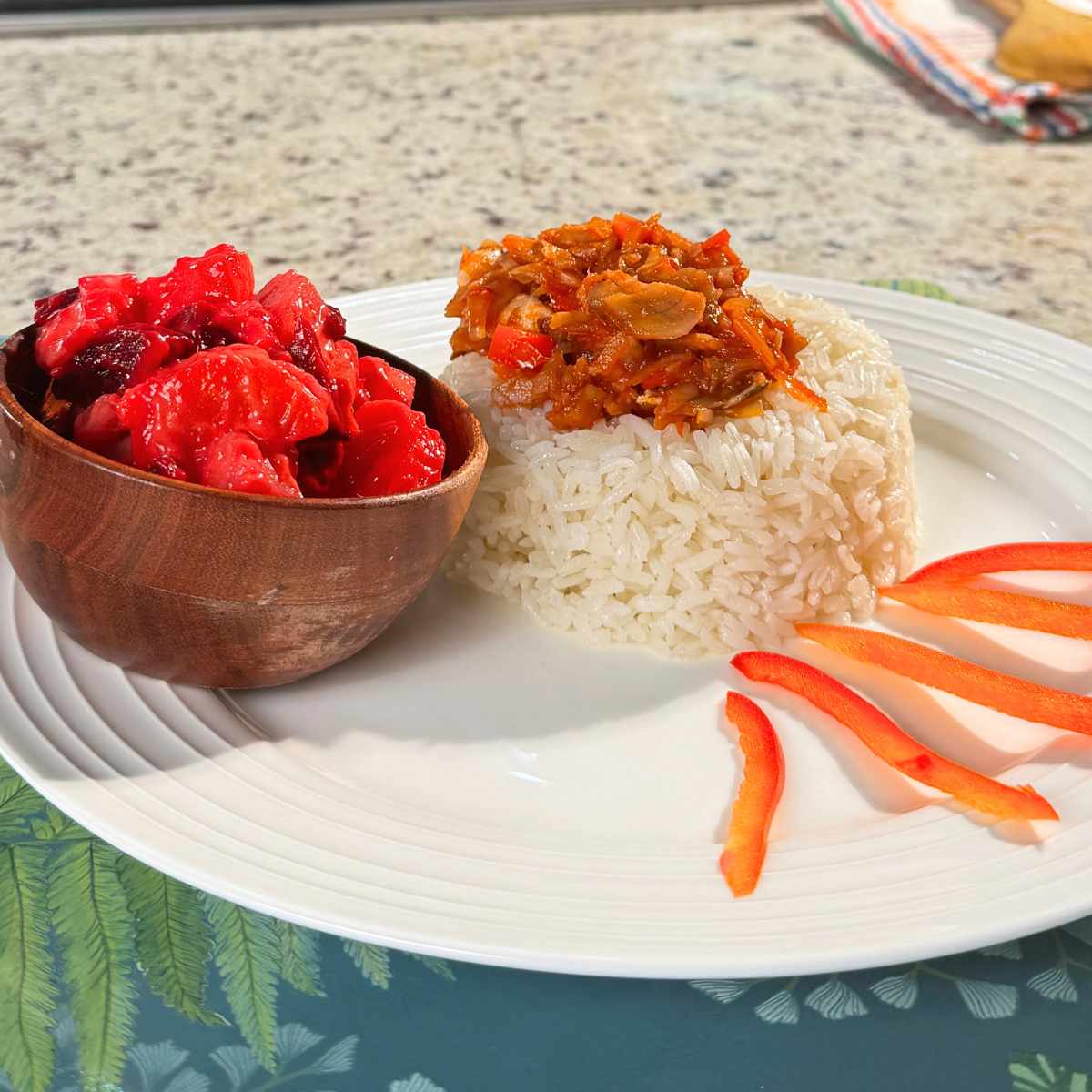 Ingredients for Dominican bacalao guisado including salted cod, tomatoes, onion, bell peppers, garlic, and herbs