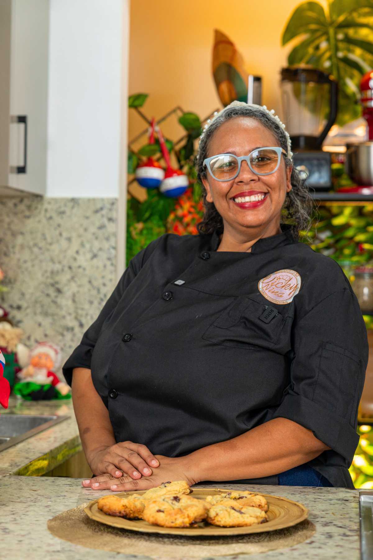 Chef sitting beside a plate of guava and white chocolate cookies